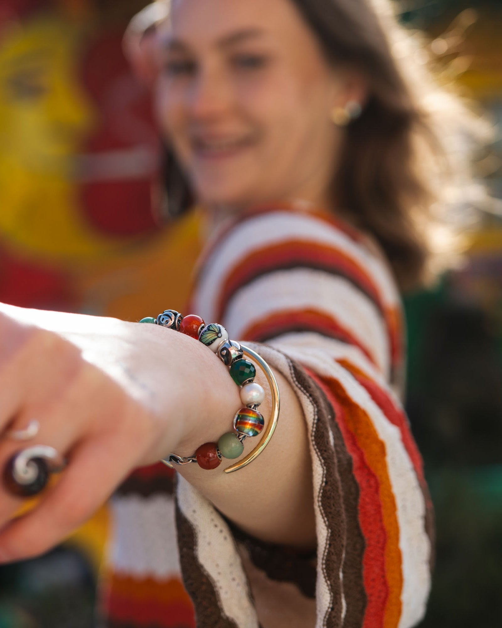 Various round jewellery beads on model wrist in happy summer colours